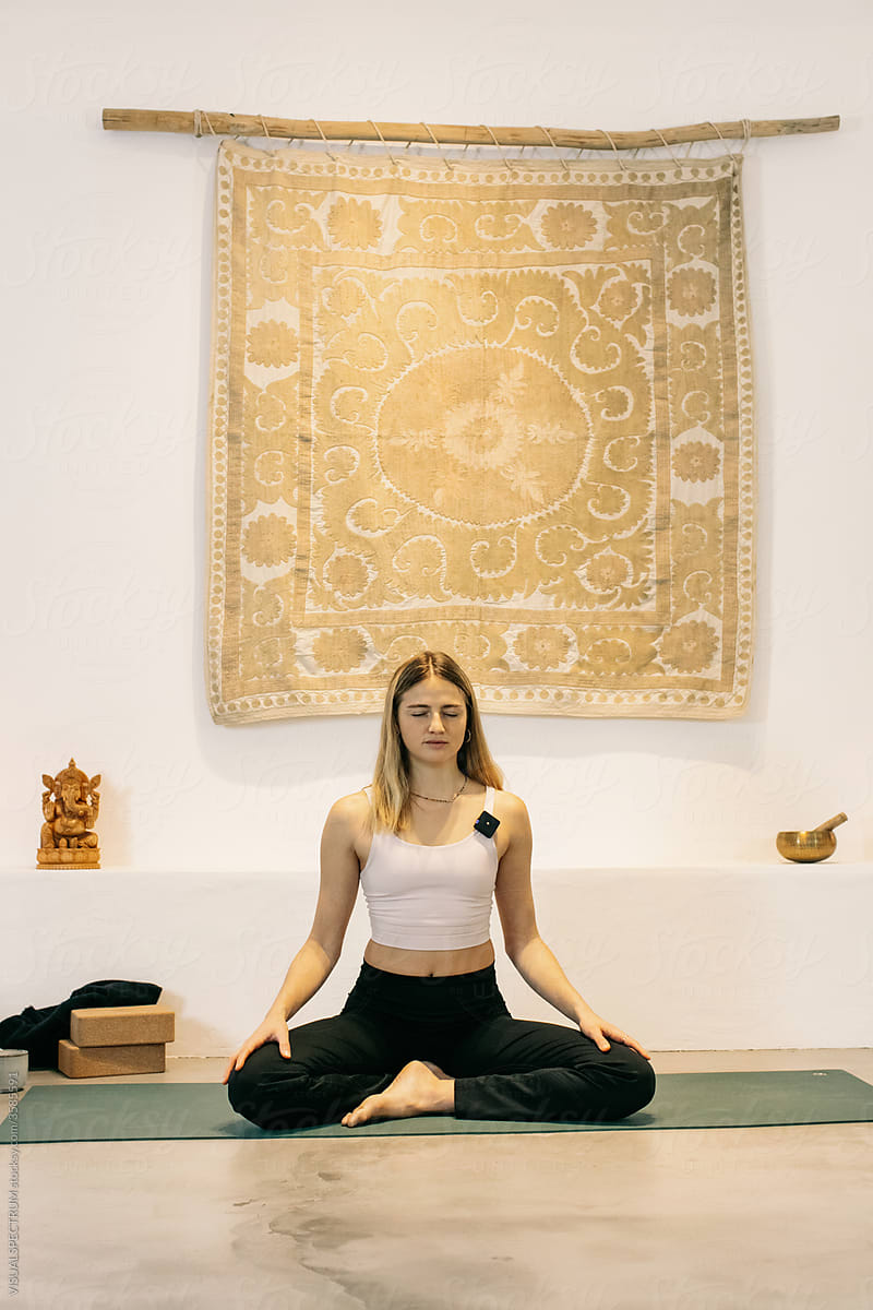Young Female Yoga Teacher Meditating
