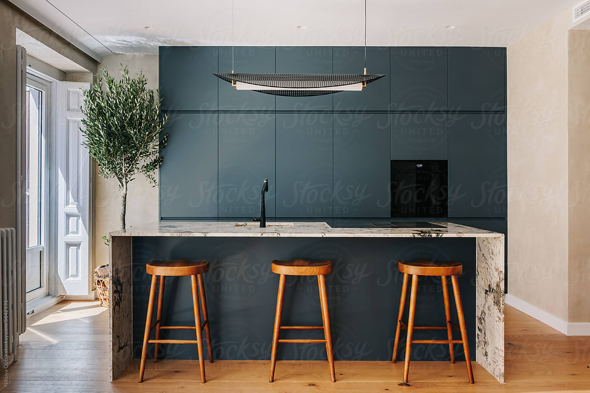 Luxury Kitchen with dark green cabinetry and marble kitchen island