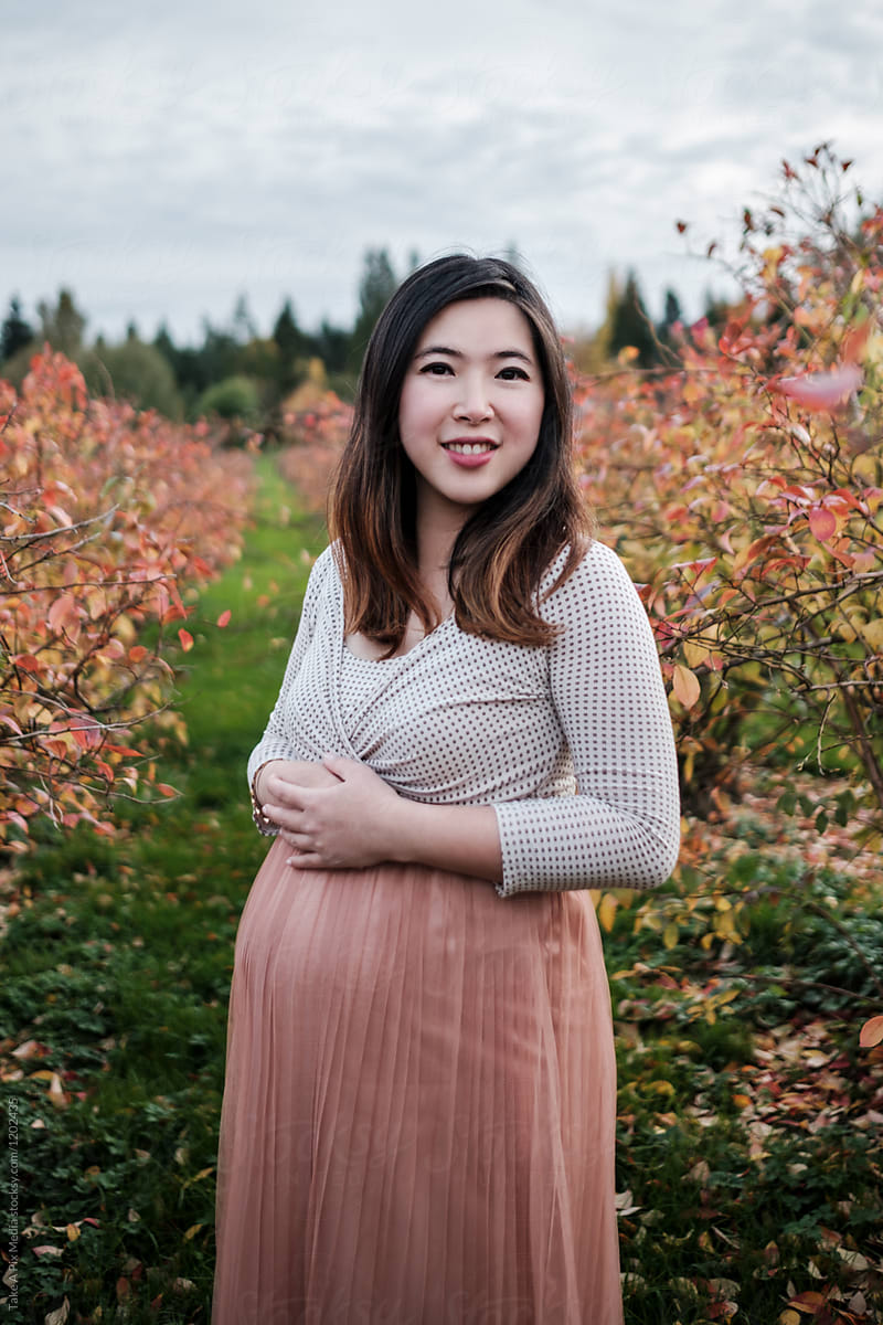 Portrait Of Pregnant Asian Woman Outdoor In A Park By Take A Pix Media