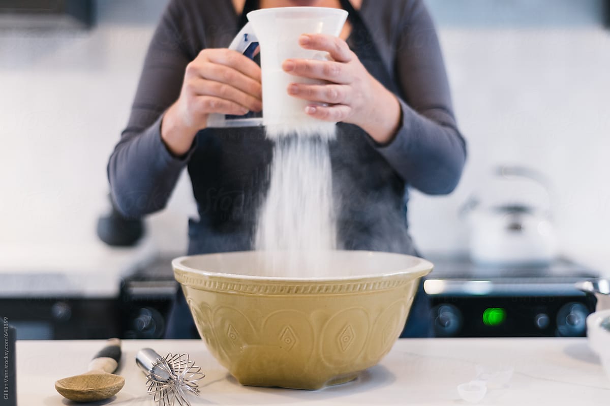 sifting flour into a mixing bowl