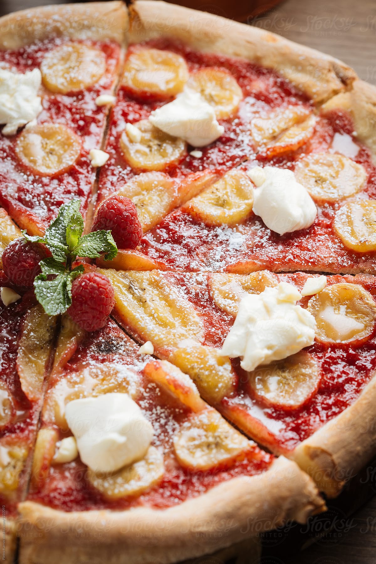 Sweet pizza with raspberry sauce and banana
