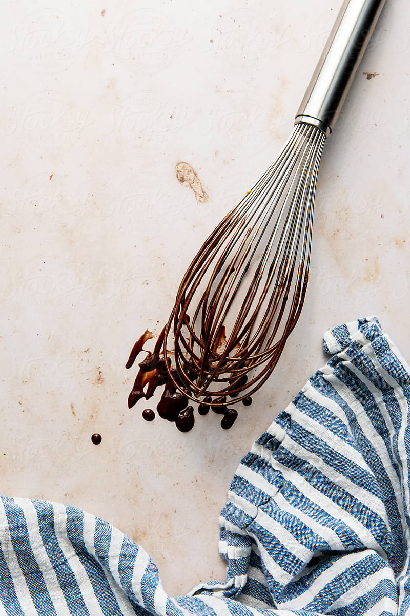 whisk dripping with chocolate batter