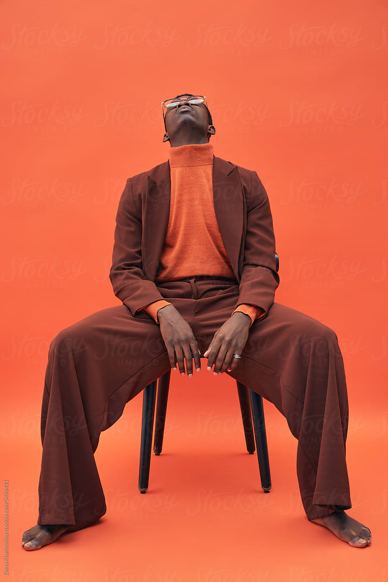 Black man model posing on chair