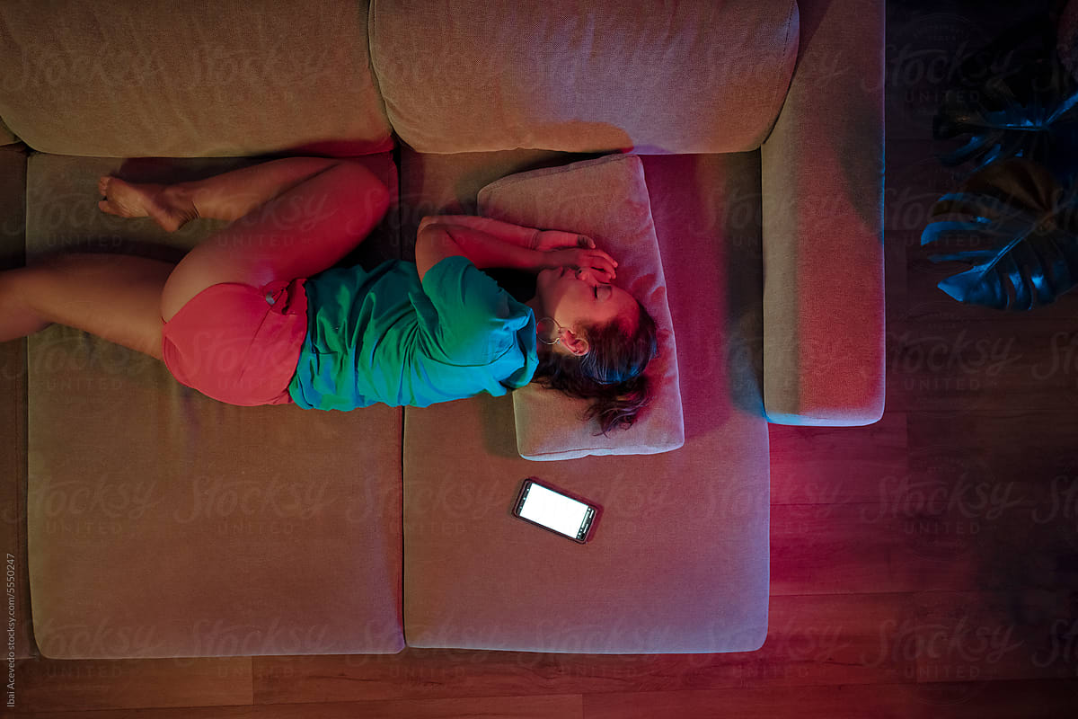 Woman sleeping on the sofa near cell phone