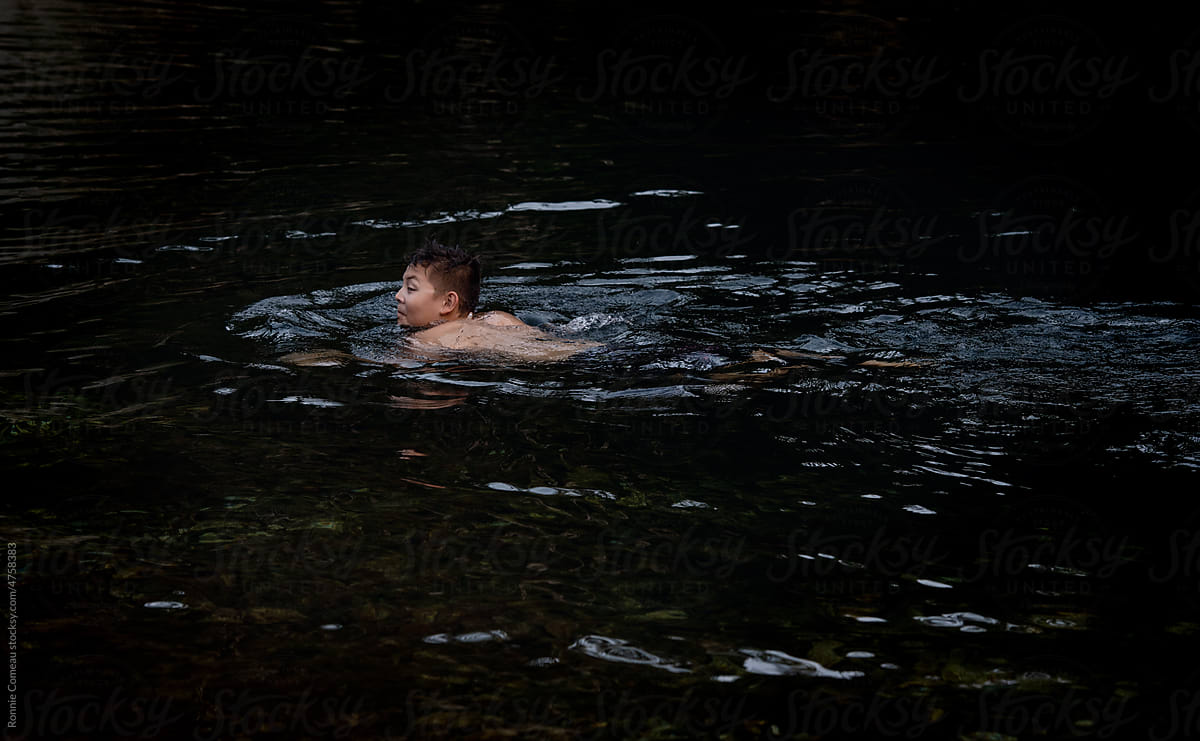 Boy Swimming in River