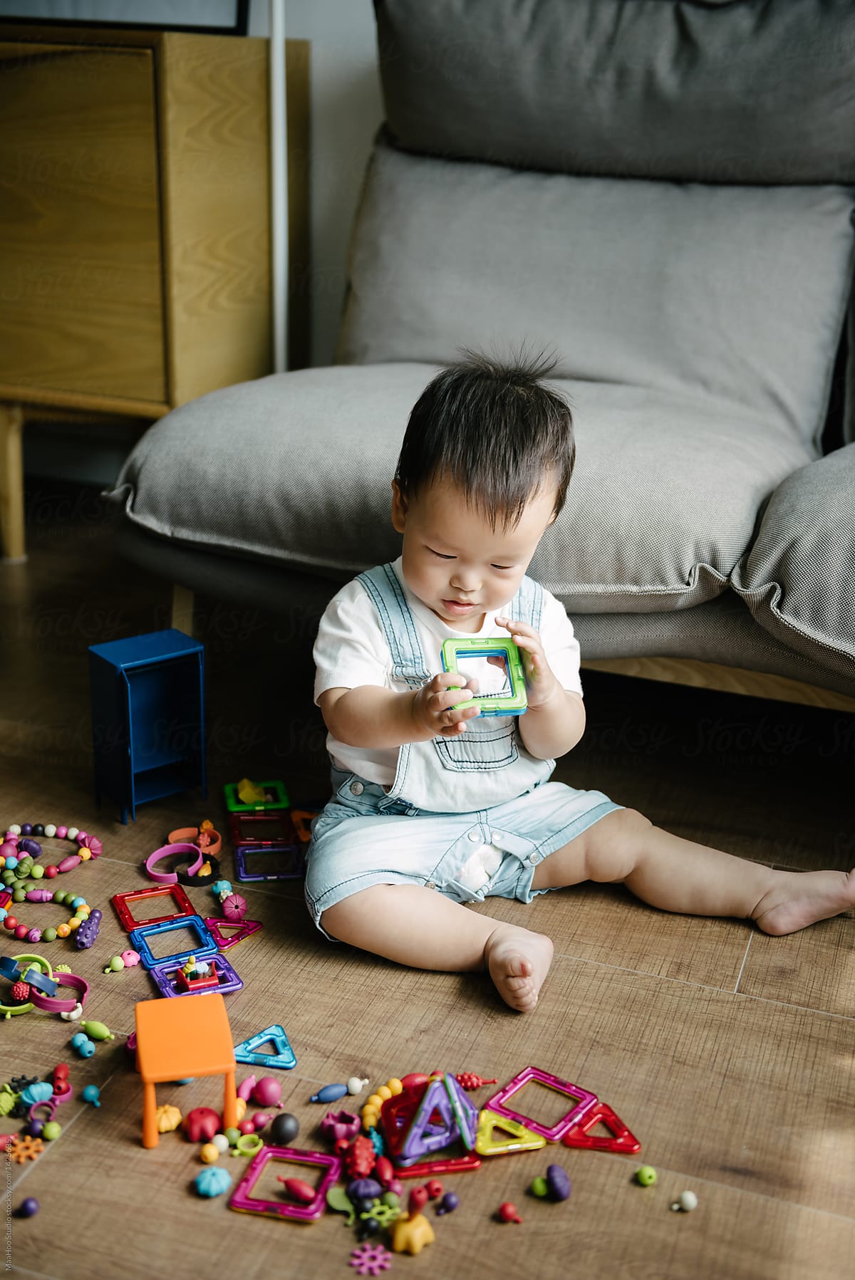 "Baby Boy Playing With Toy At Home" by Stocksy Contributor "MaaHoo ...