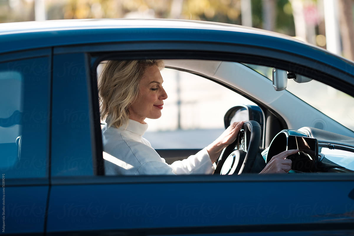 Woman Using GPS Navigator In Car
