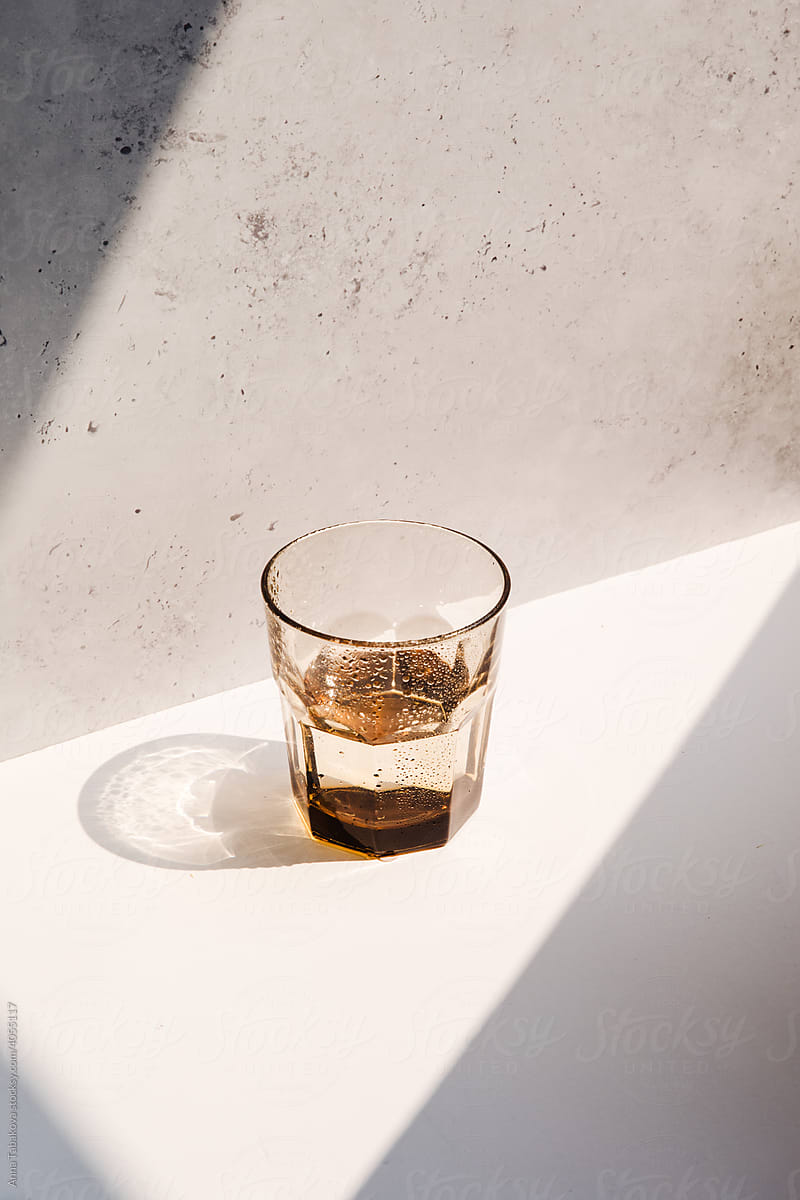 Brown glass cup with a water in it