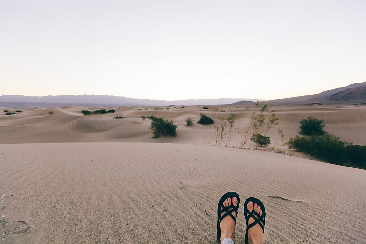 Woman\'s Feet Relaxing in Desert Sand in Daylight