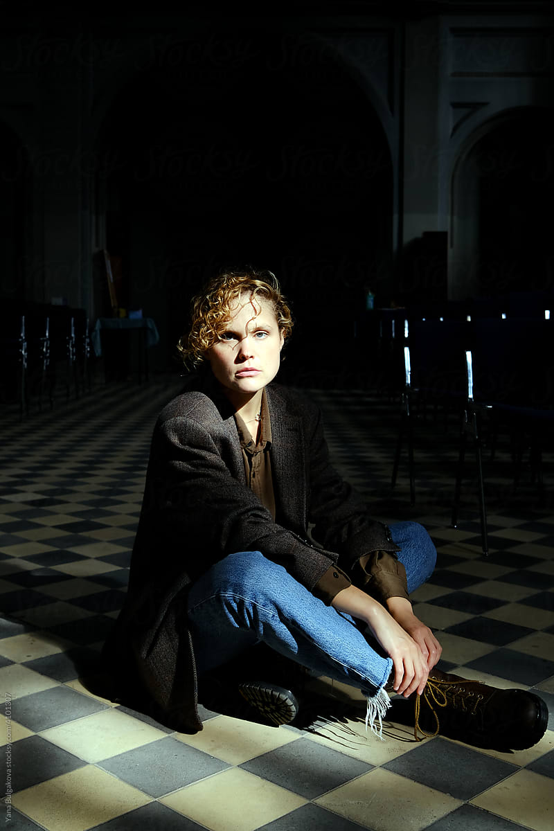 Young woman sitting on the floor in Catholic church