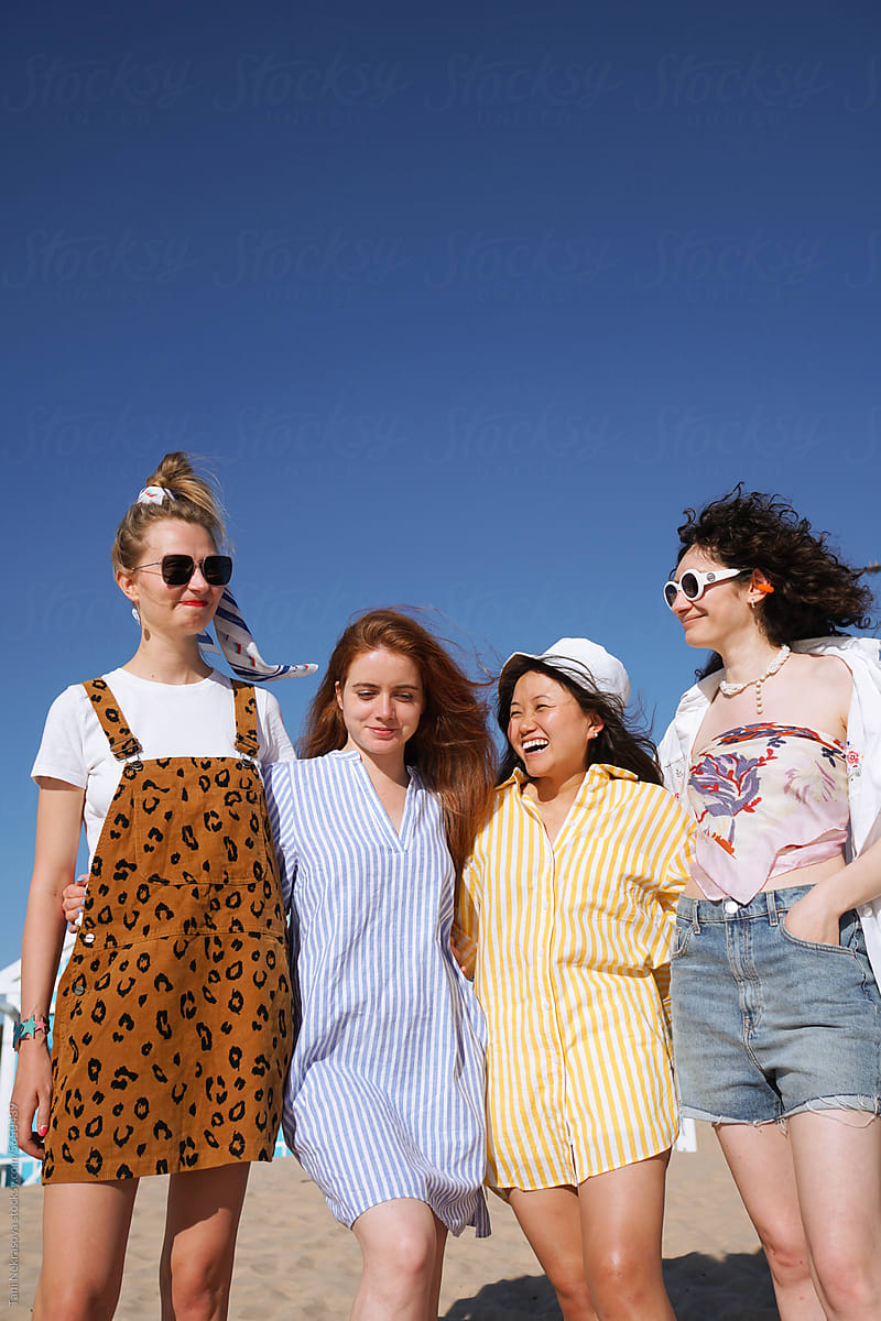 Four young female friends traveling together by the ocean. Friendship