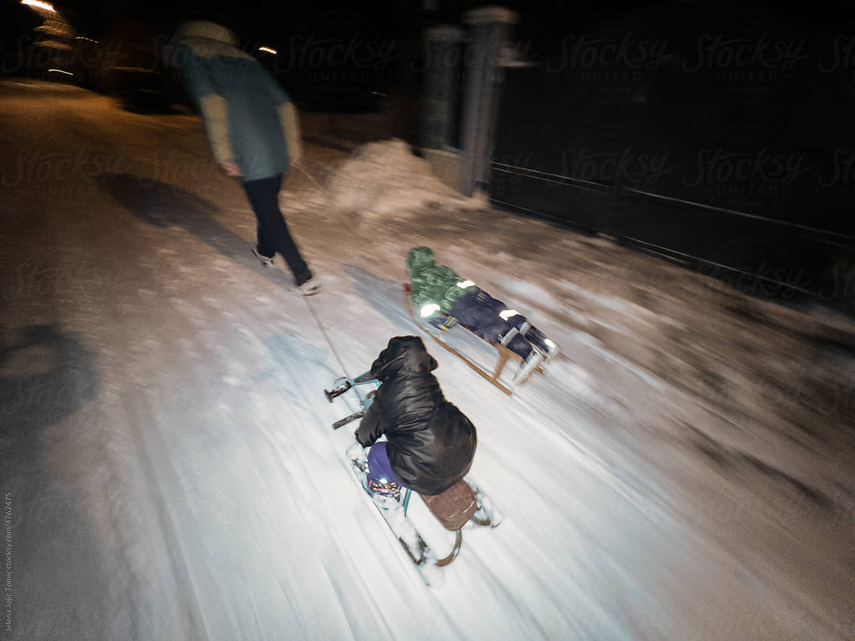 Family winter sled ride on snow, outdoors