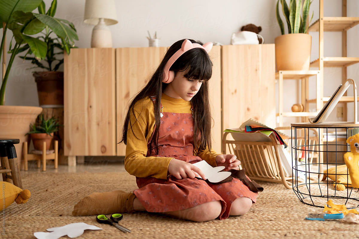 Contemporary girl making handcrafts at home