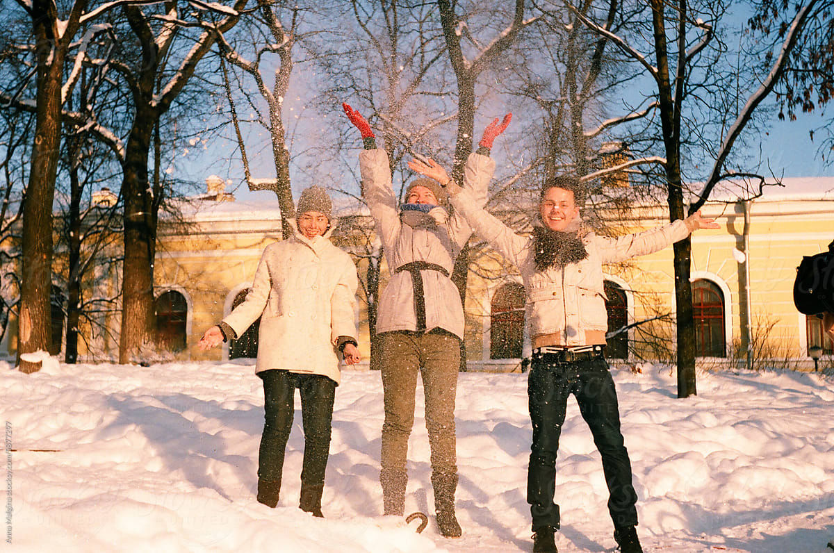 Three Friends Enjoying a Snowy Day Together