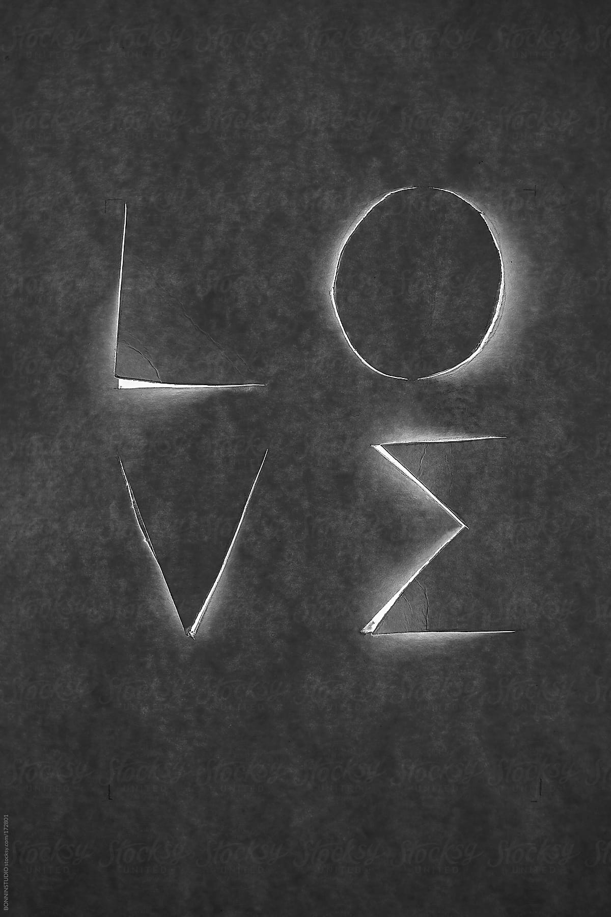 Love word cropped on cardboard. Black and white photo.