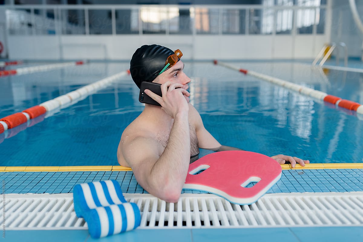 Swimmer talking on phone in pool