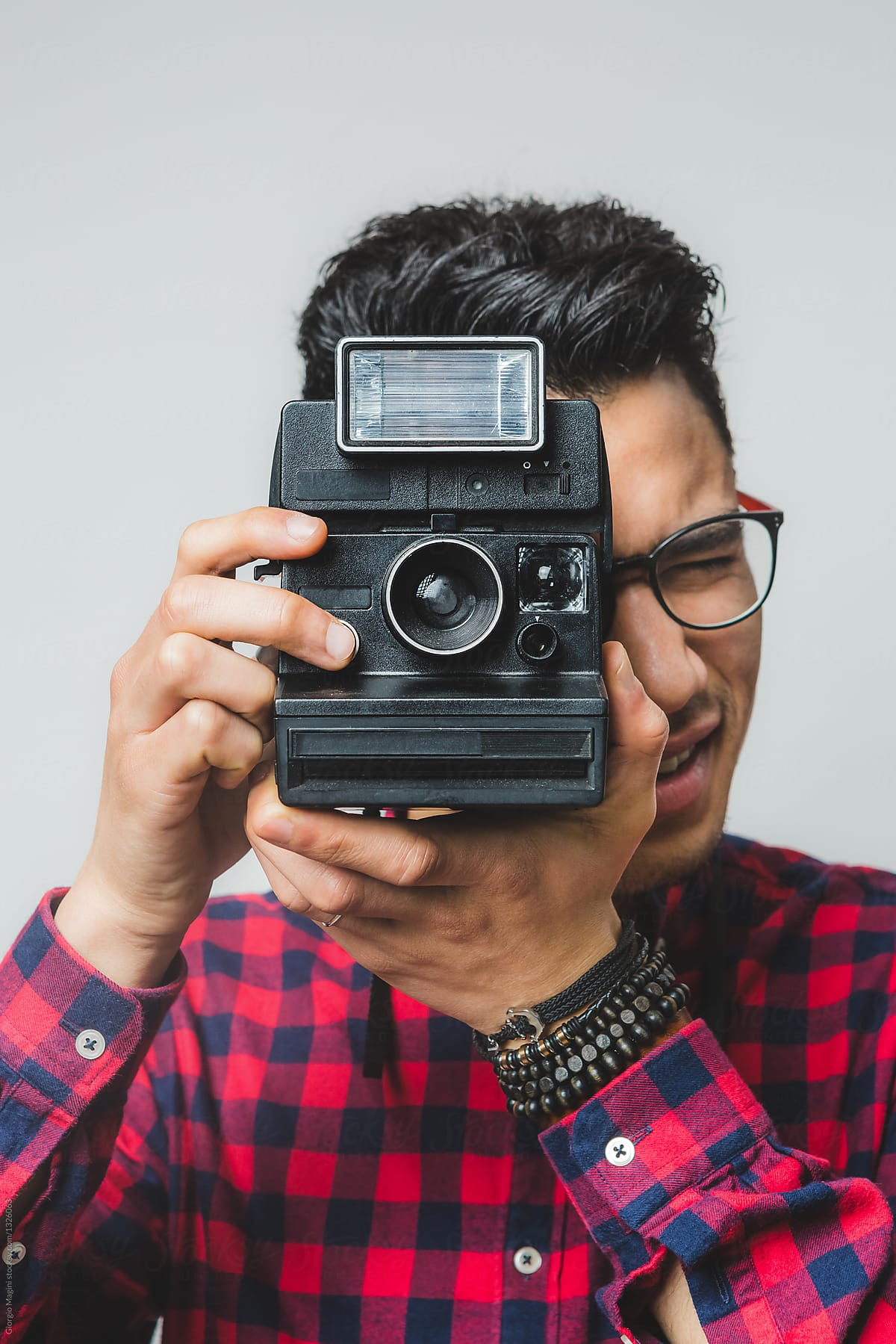 Young Creative Man Using a Retro Instant Camera