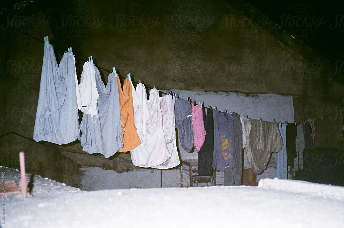 Clothes hanging from a wire and drying outside at night with flash