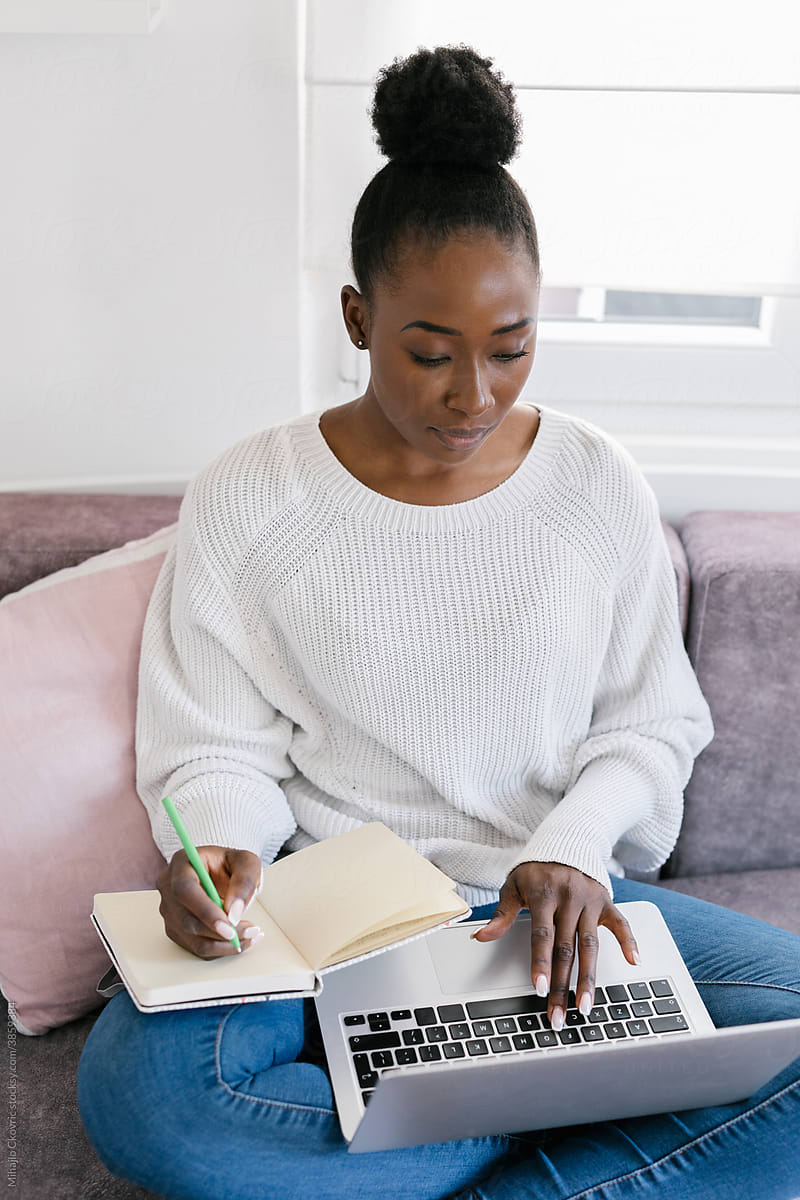 Young black woman studying at home