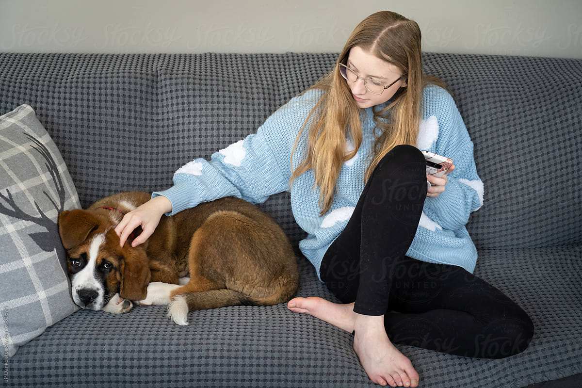 Teen Girl Sitting With Large Breed Puppy Dog