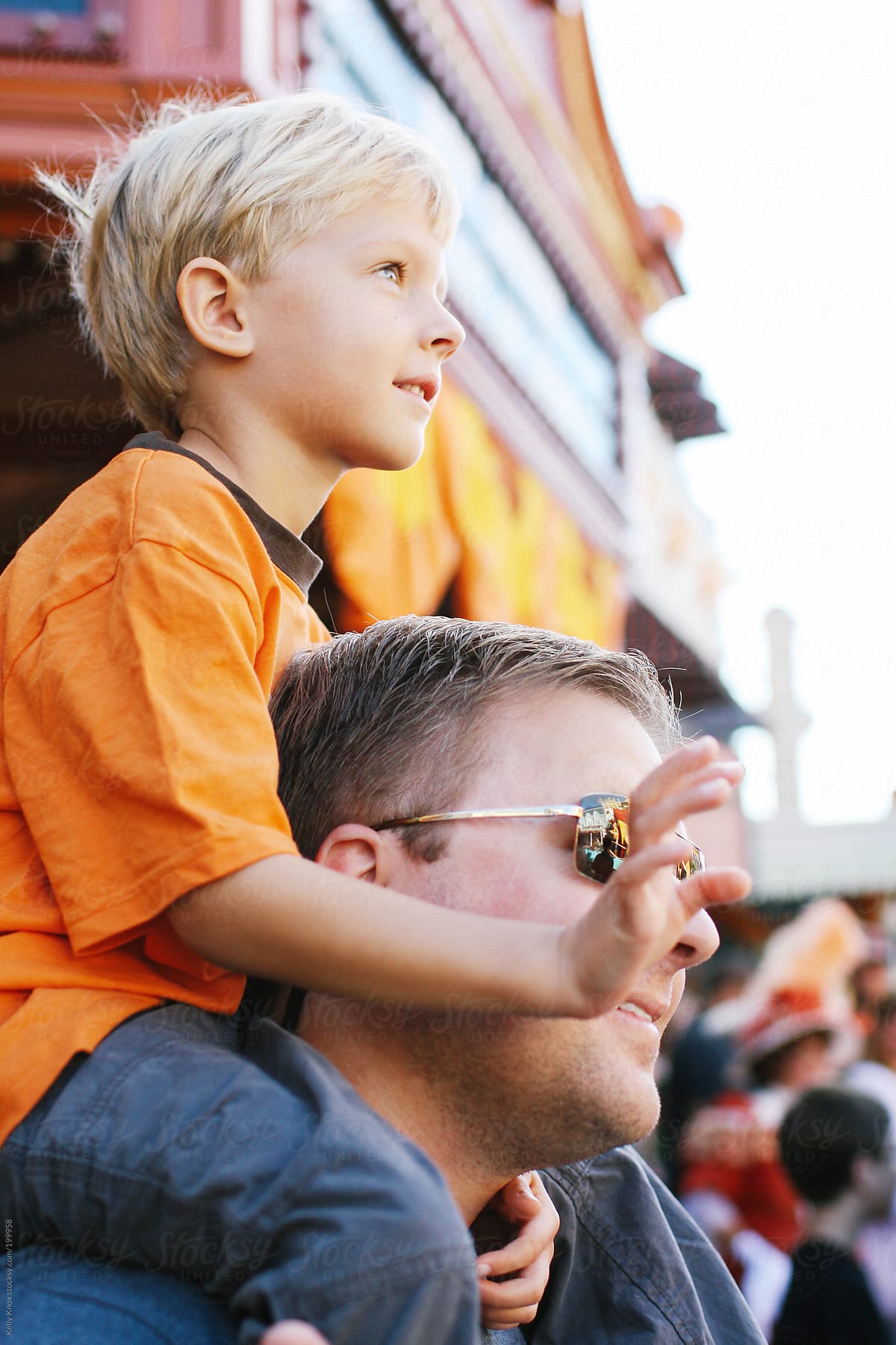 child and father watch a parade