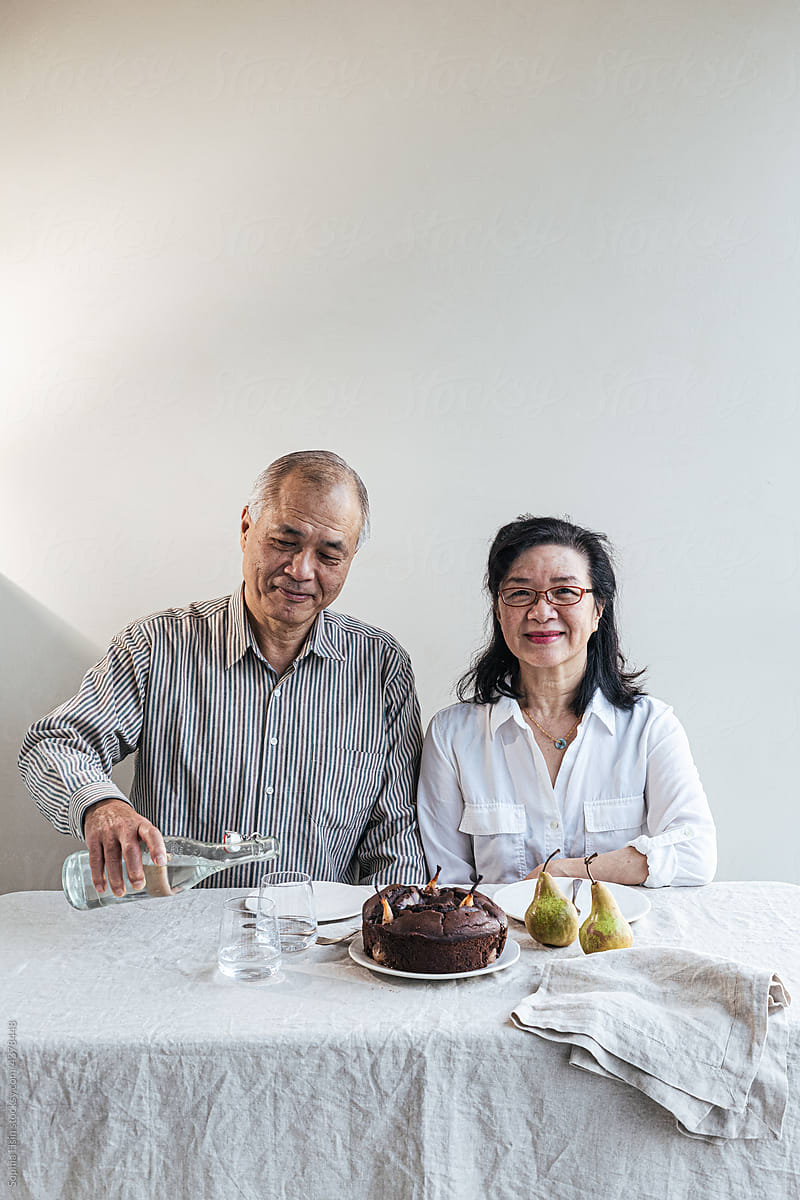 An older couple celebrating with cake