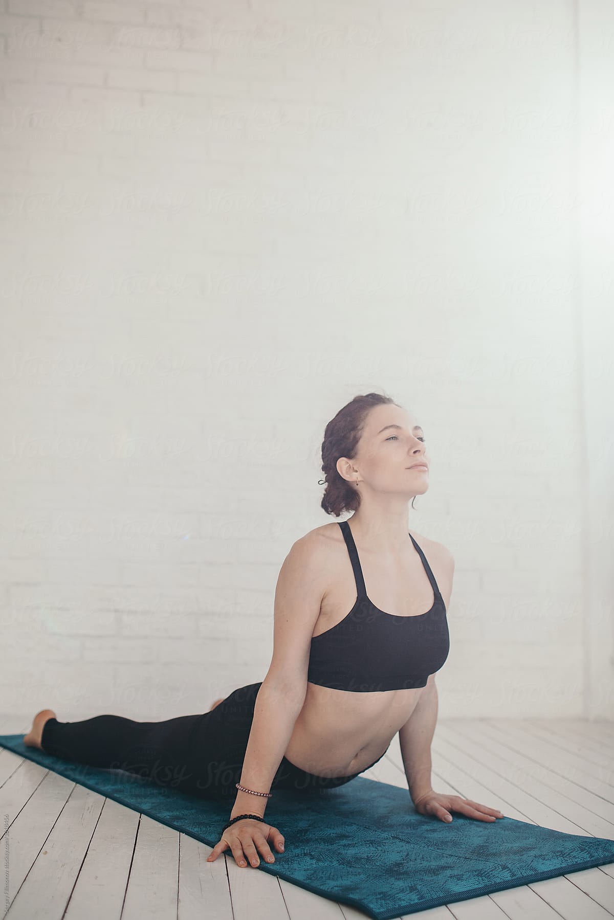 Young woman doing yoga exercises indoors