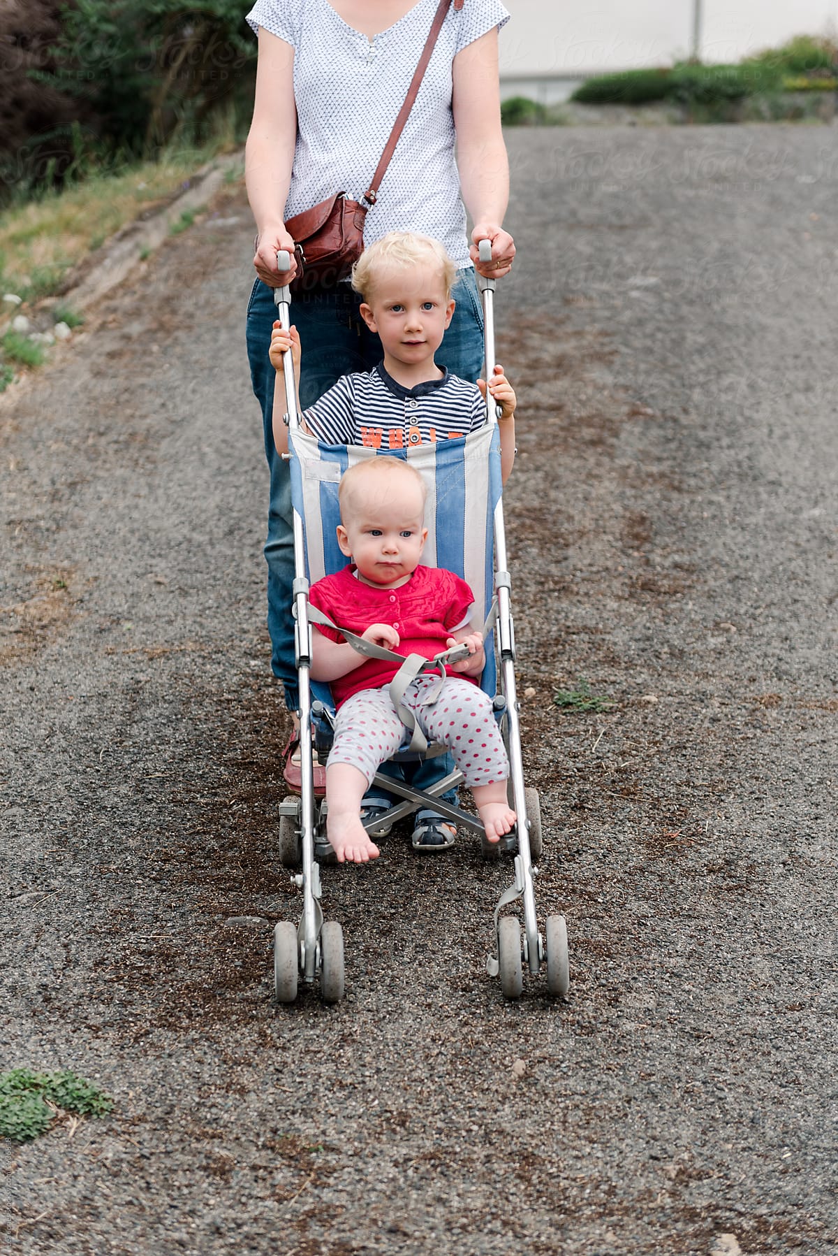 mother with toddler and baby on a walk