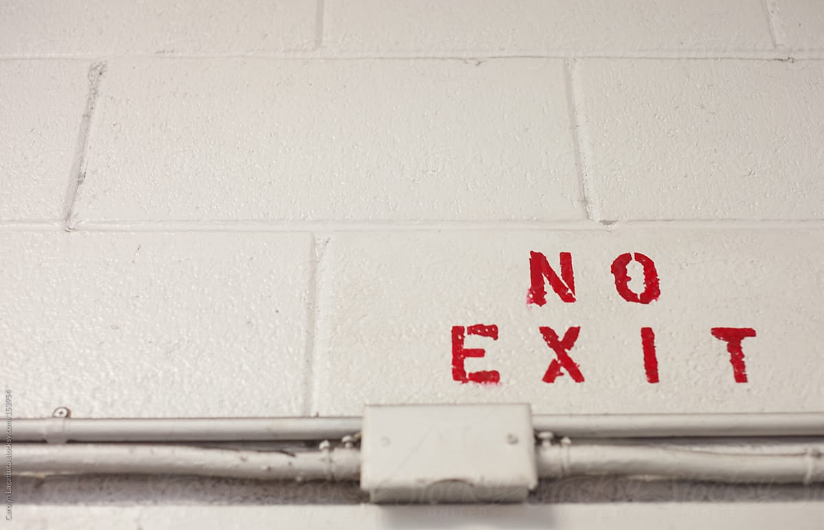No Exit in red letters on a brick wall