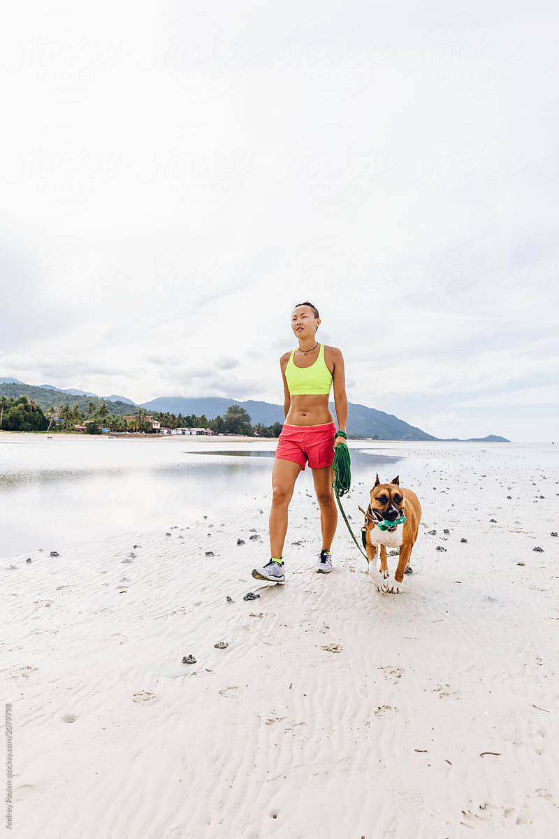 Fitness with a dog on the beach
