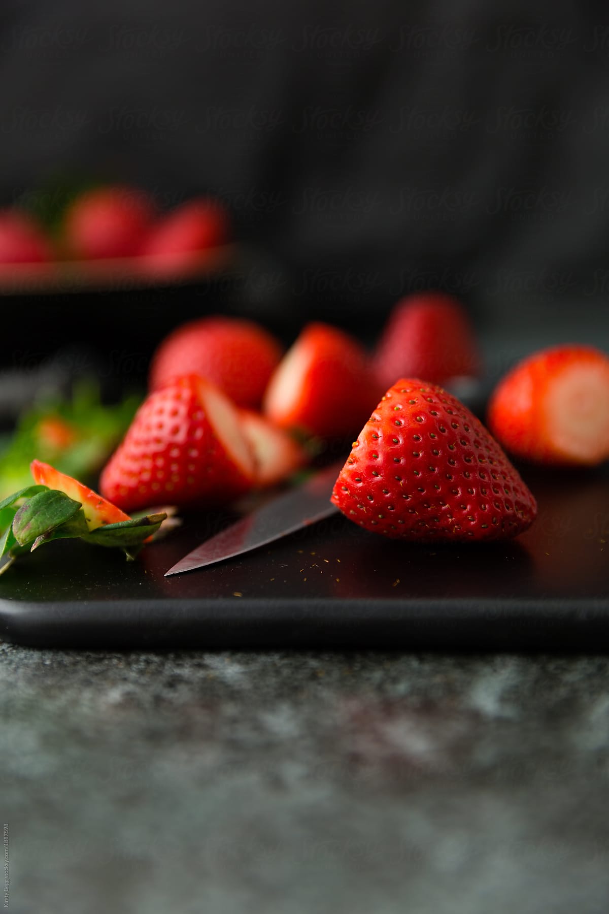 Close up of topped strawberries on chopping board