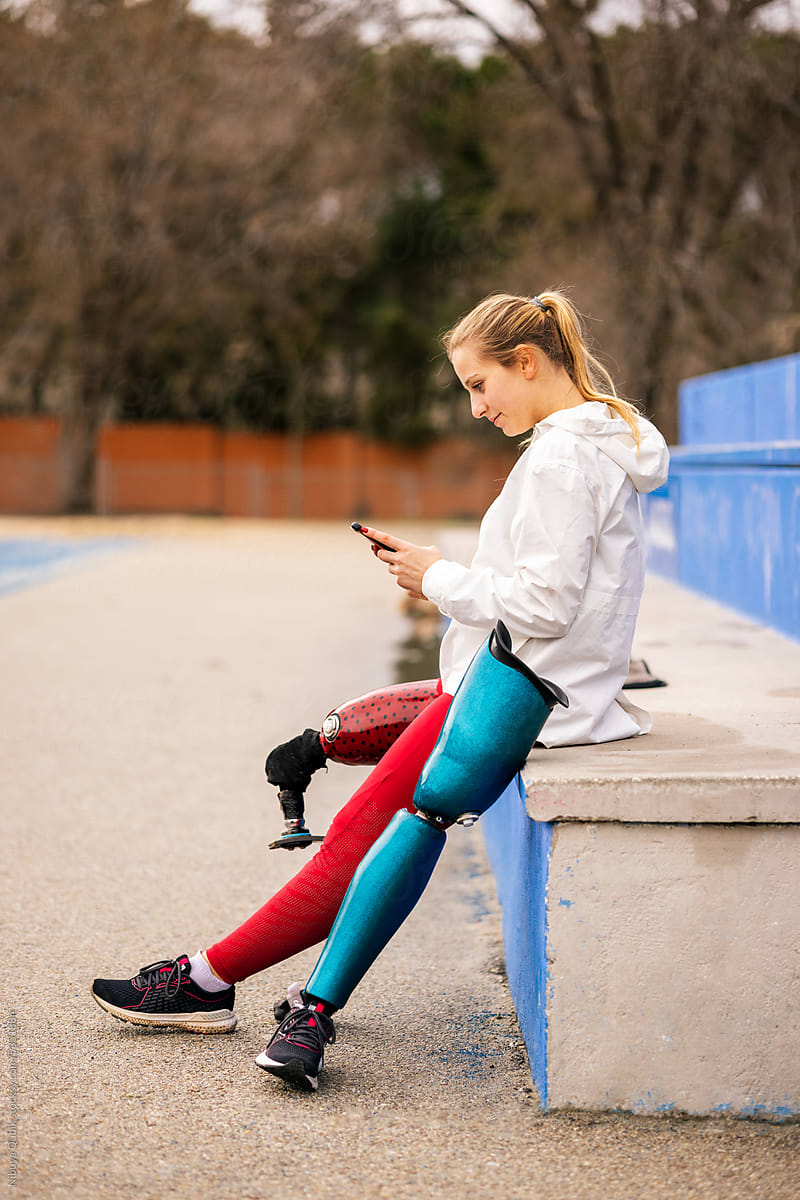 Paralympic athlete resting after training and checking her phone