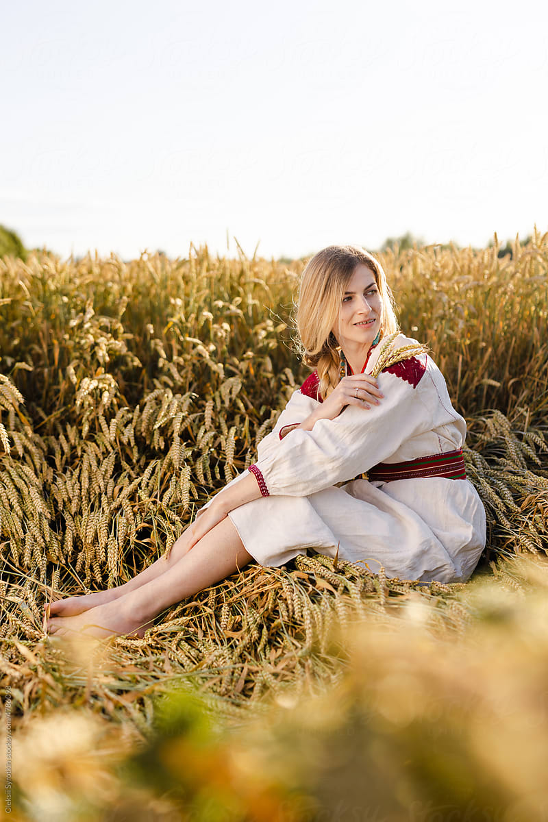 Ukrainian girl among wheat meadow