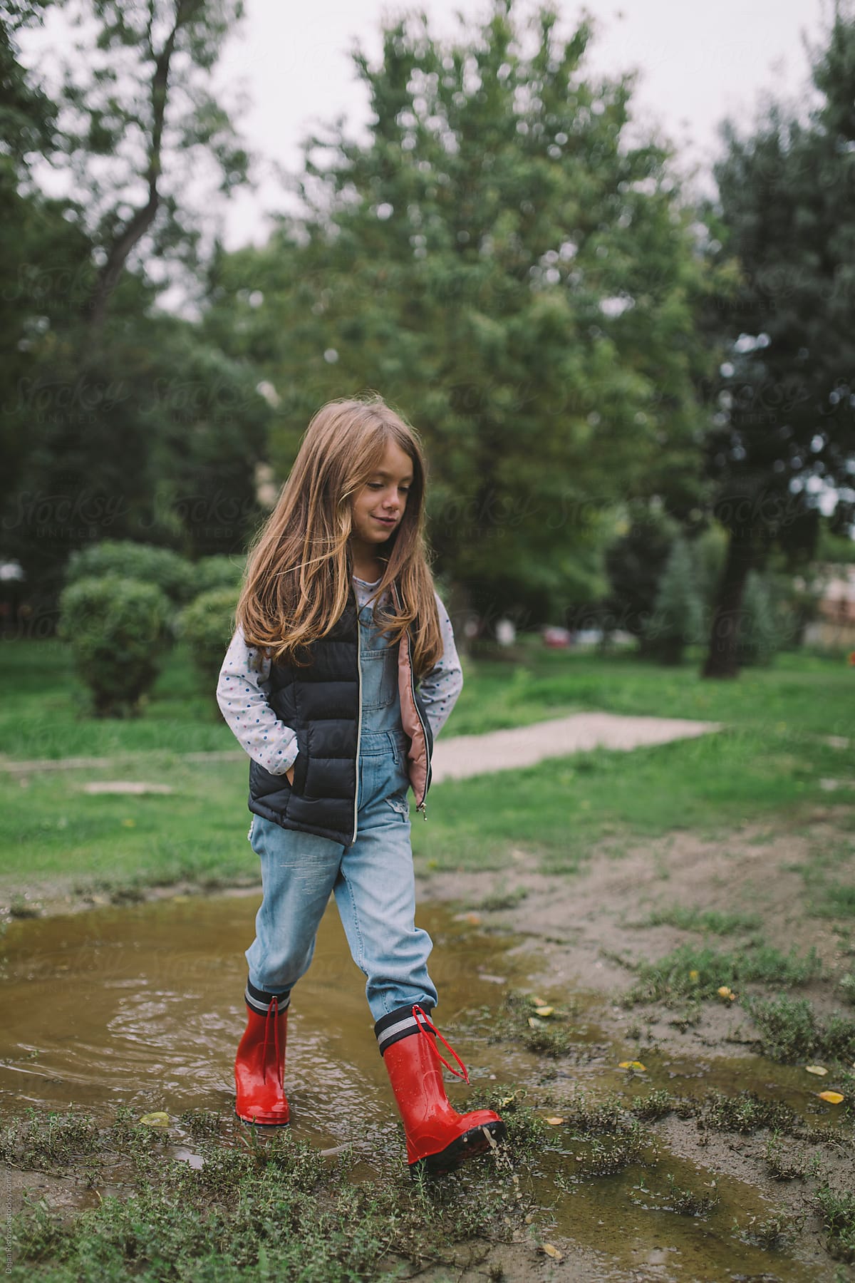 Child walking in water after rain
