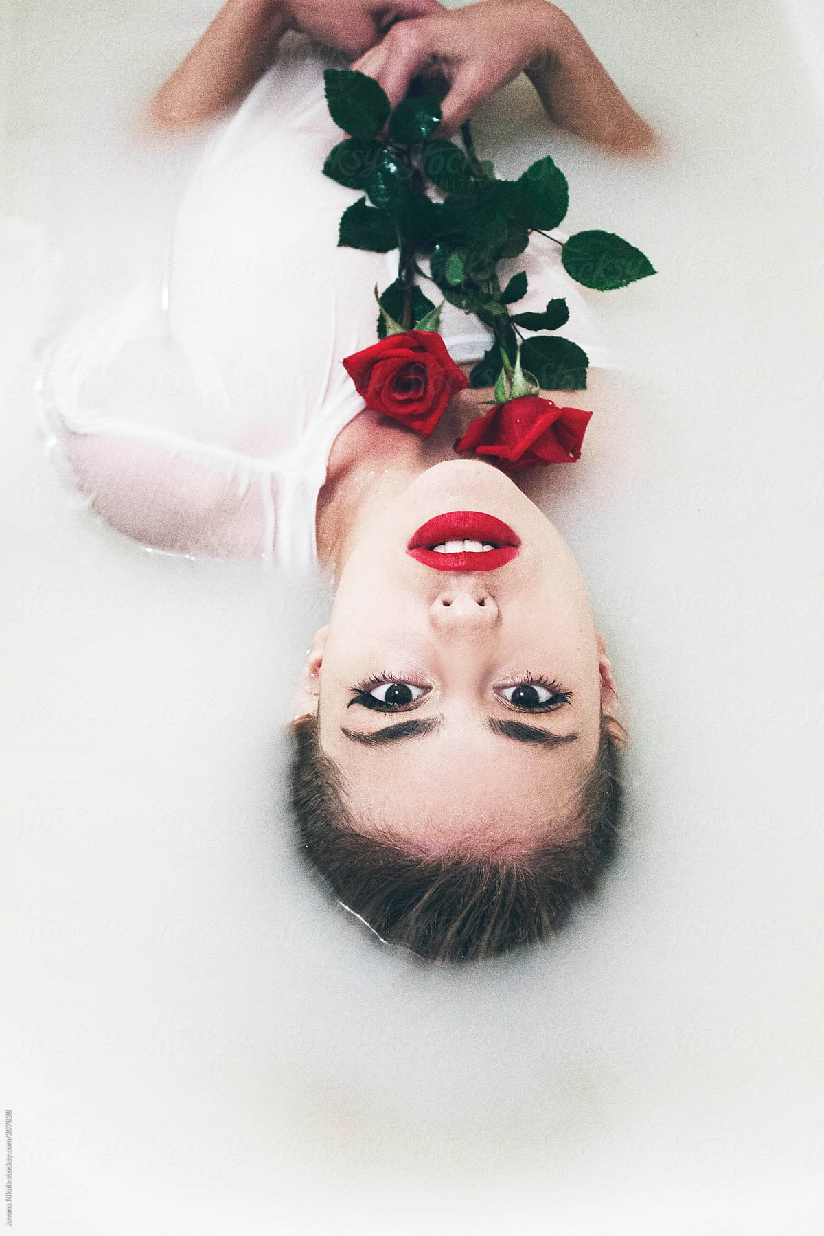 An Attractive Young Woman Lies In Milk Bath By Stocksy Contributor