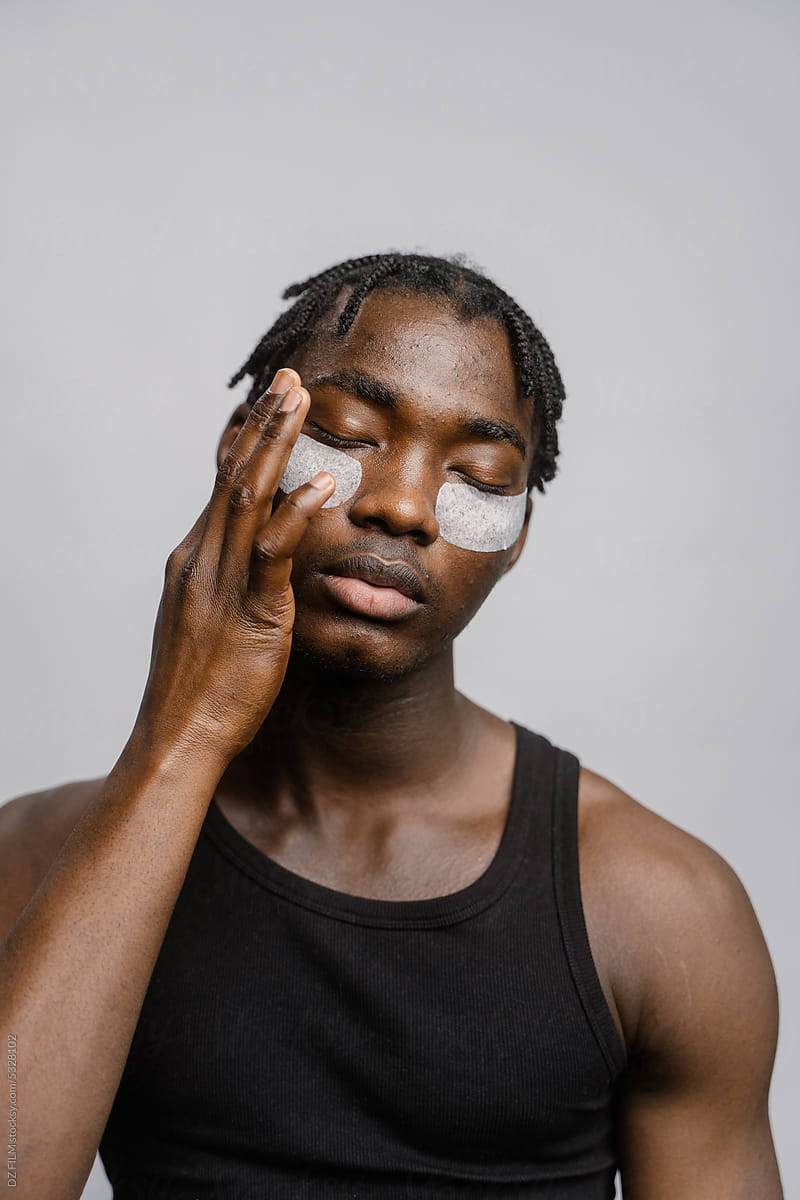 A man puts patches under his eyes