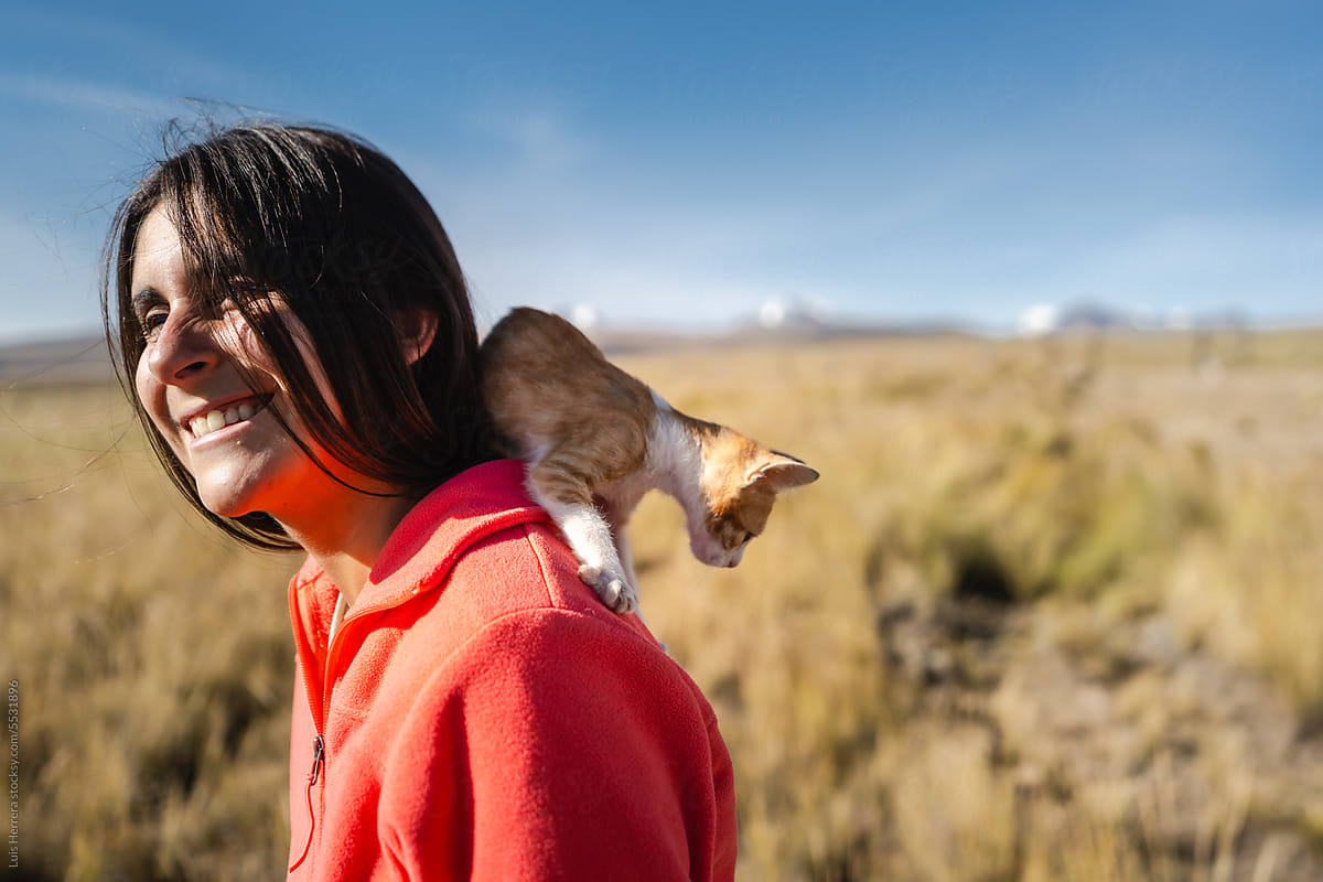 Happy Woman and Kitten Enjoying a Carefree Day outdoors
