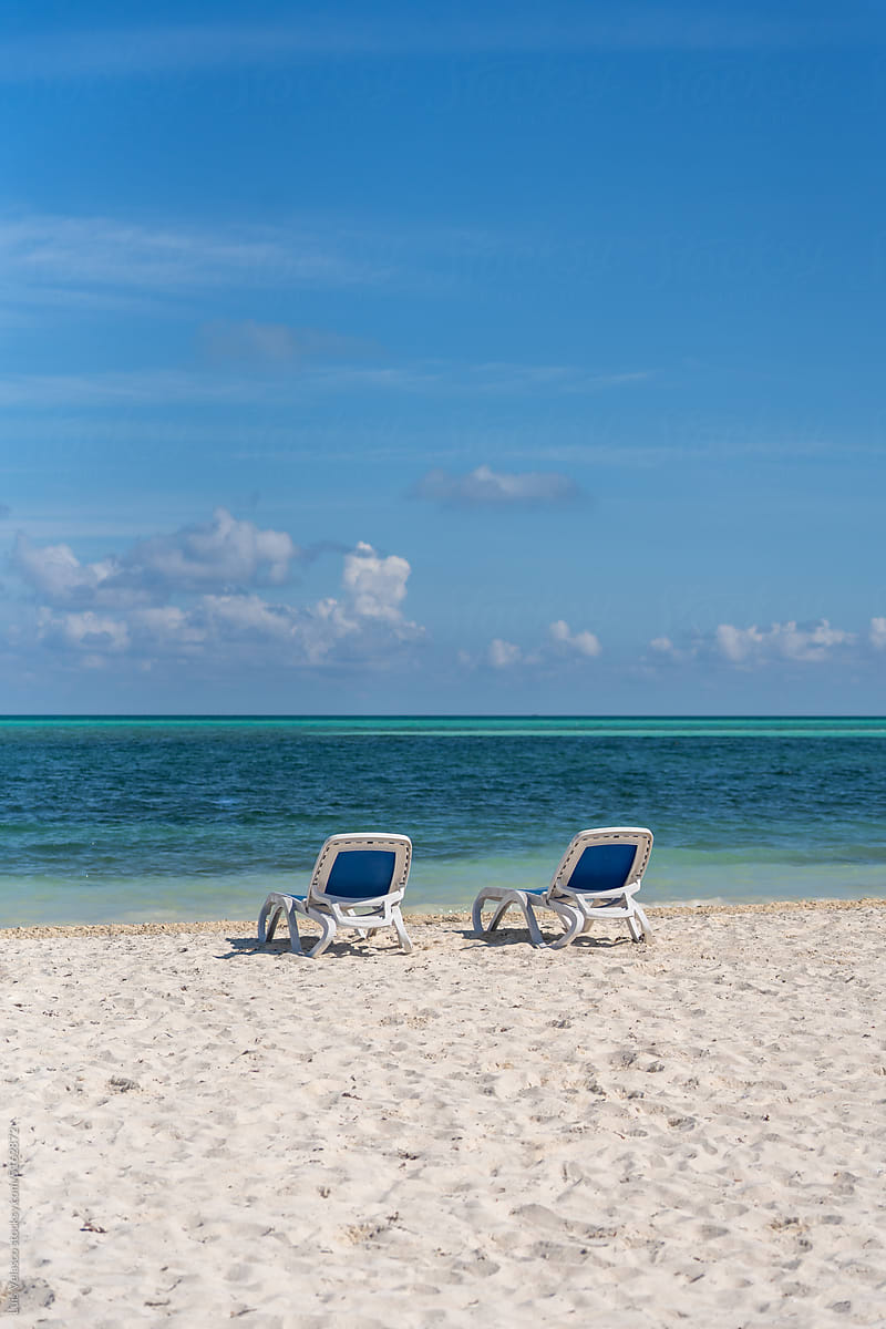 Beach With Two Chairs On The Seashore