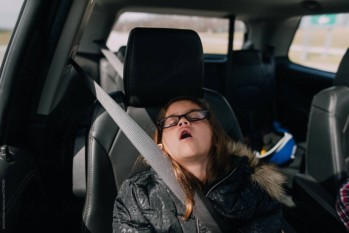 Girl sleeping with mouth open in the car.