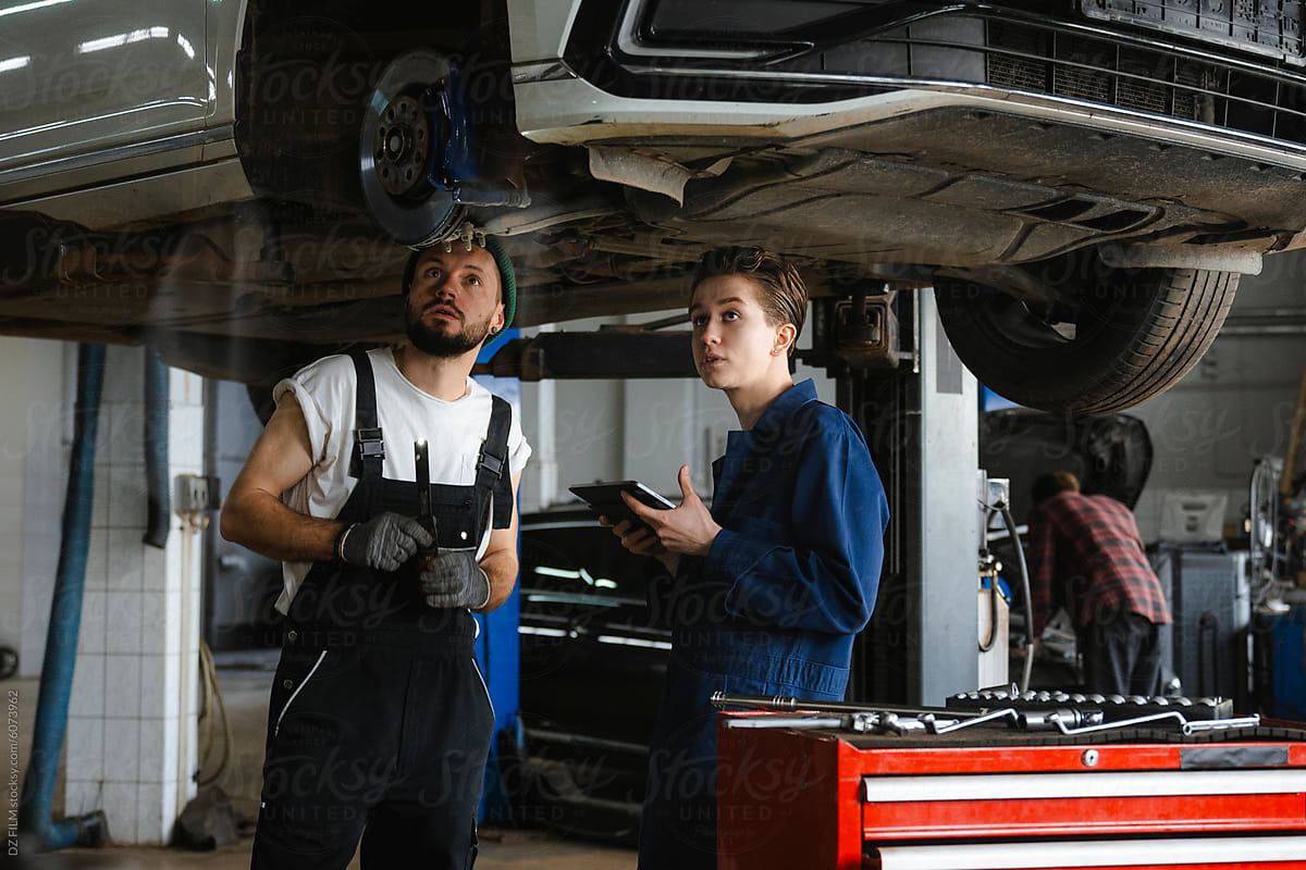 A group of people working in an auto repair shop
