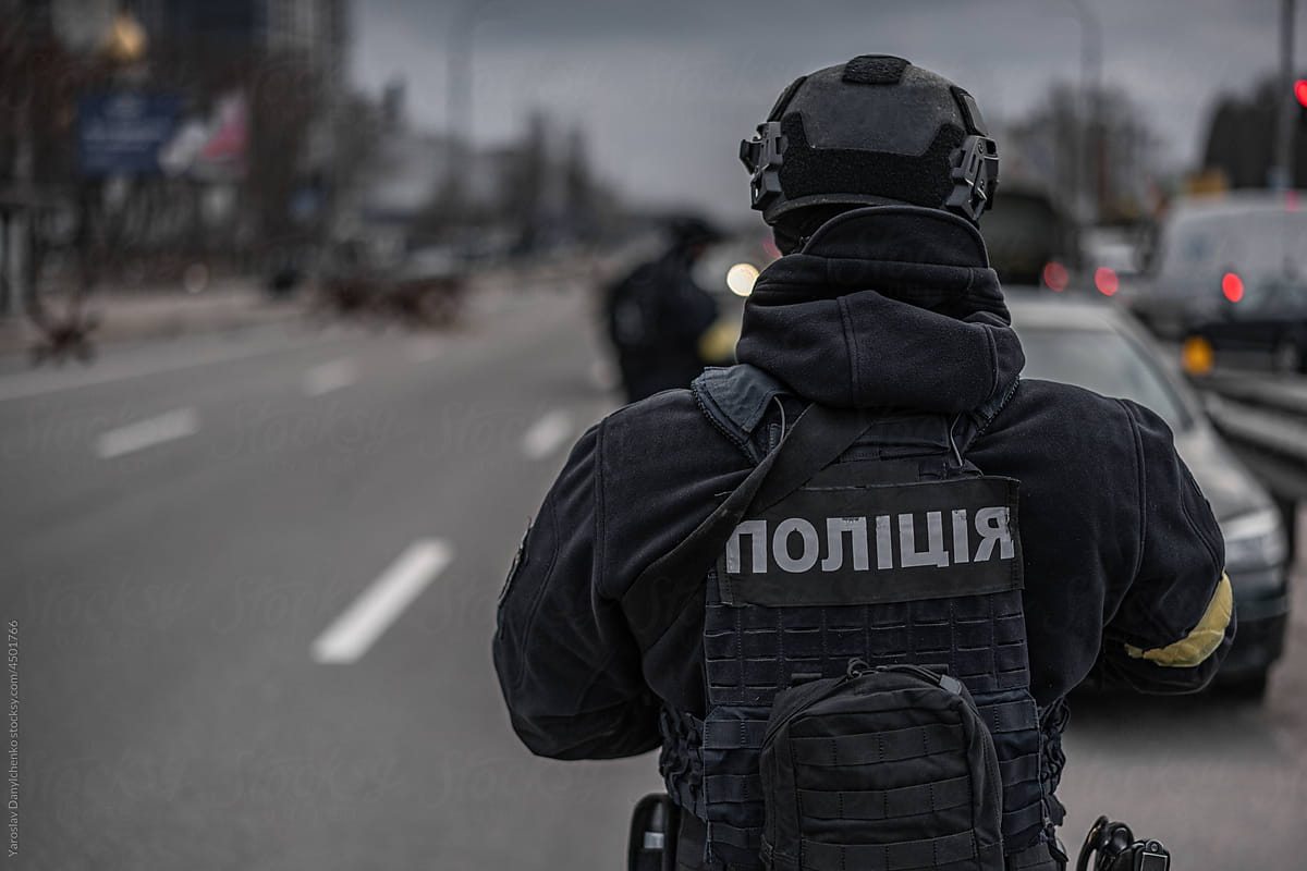 Ukrainian police officer in uniform patrolling streets