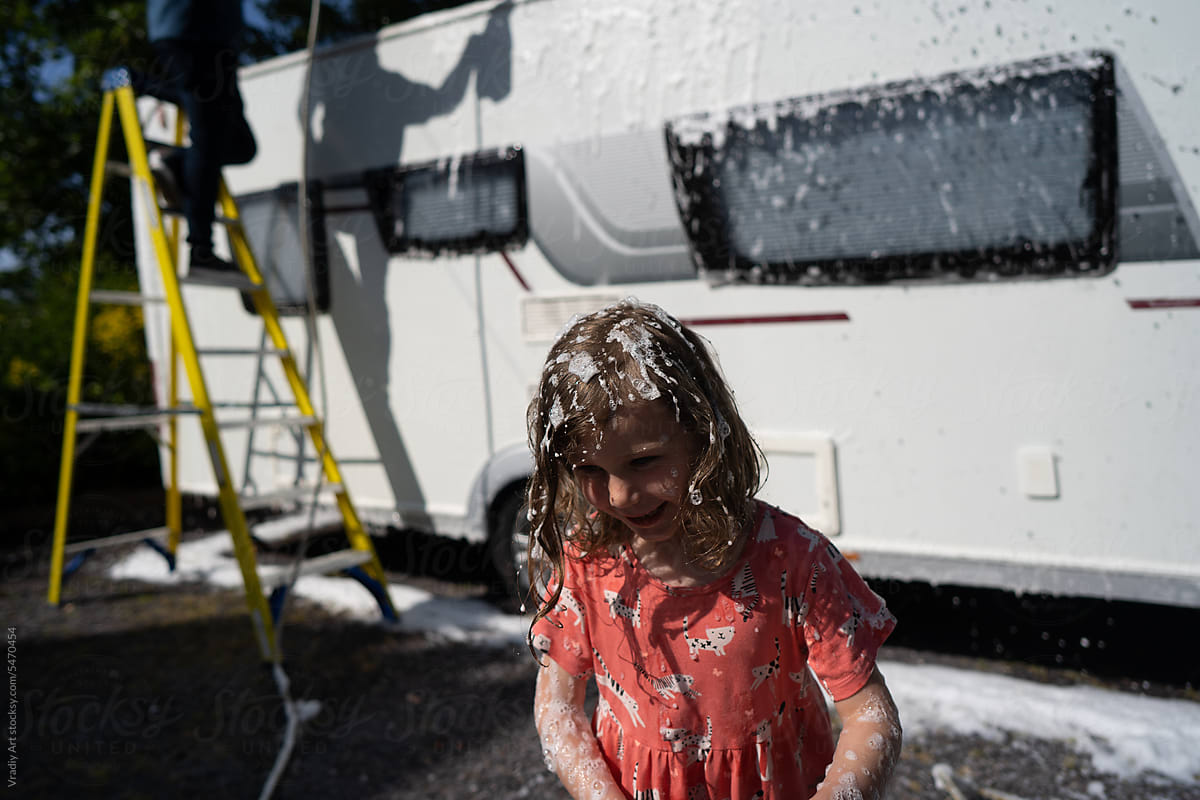 Little girl washing the van