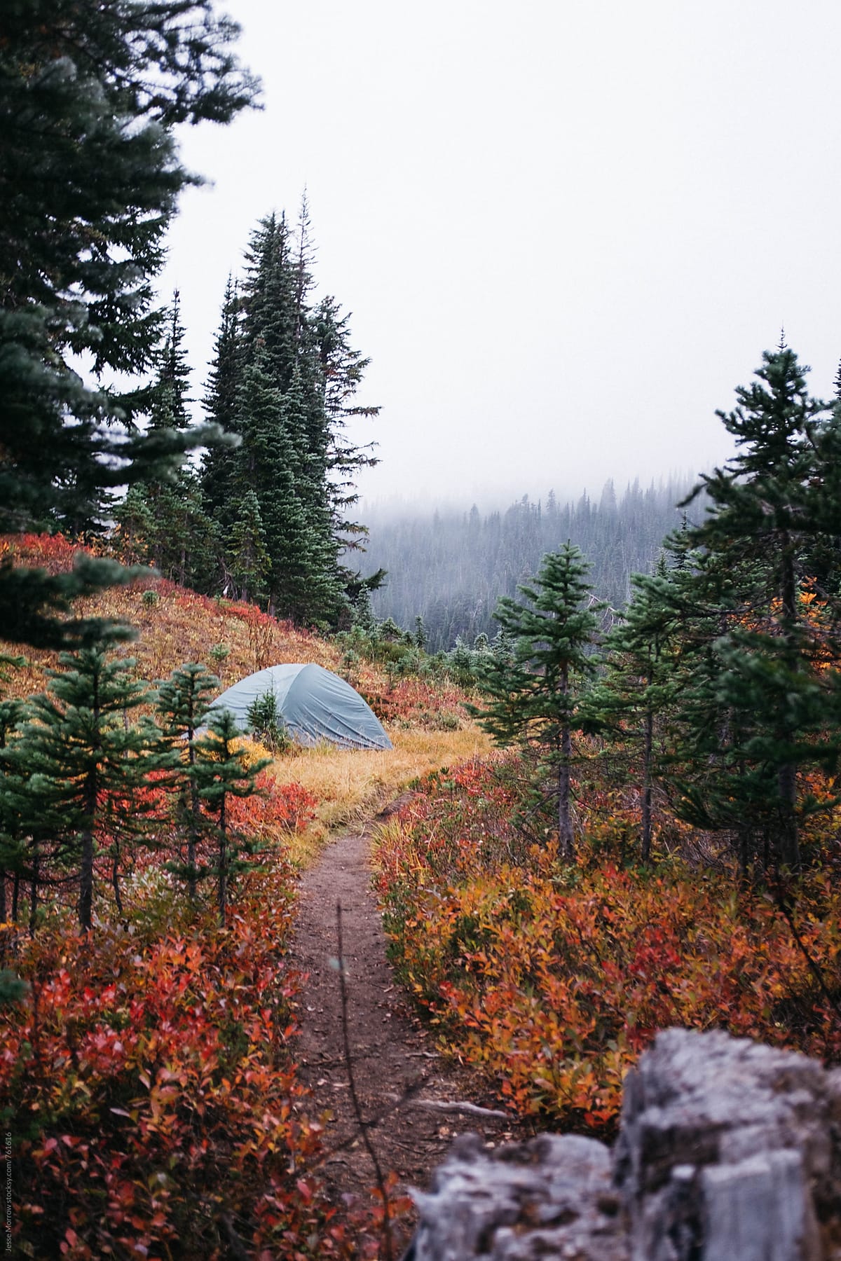 small tent set up on trail in fall colors high mountain northwest