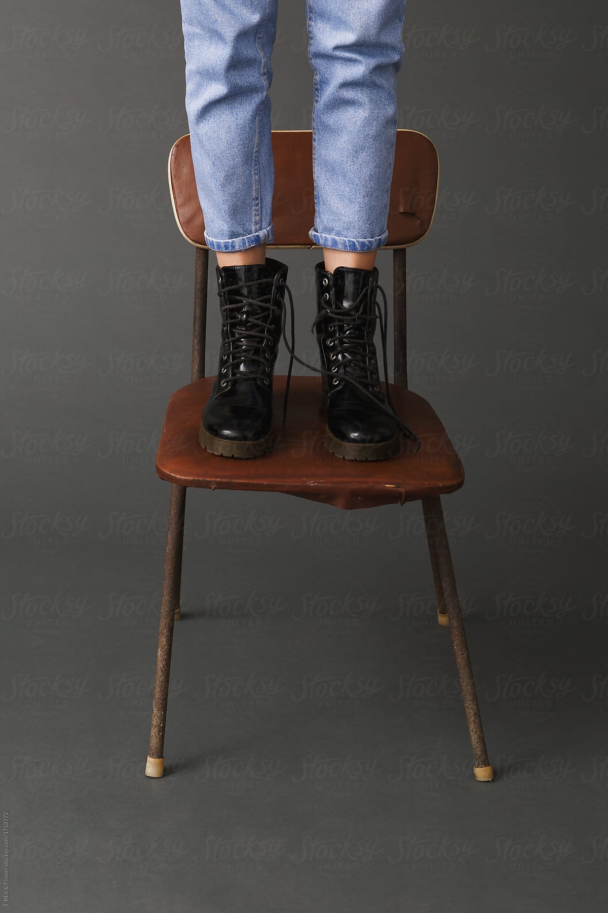 Woman standing on old chair
