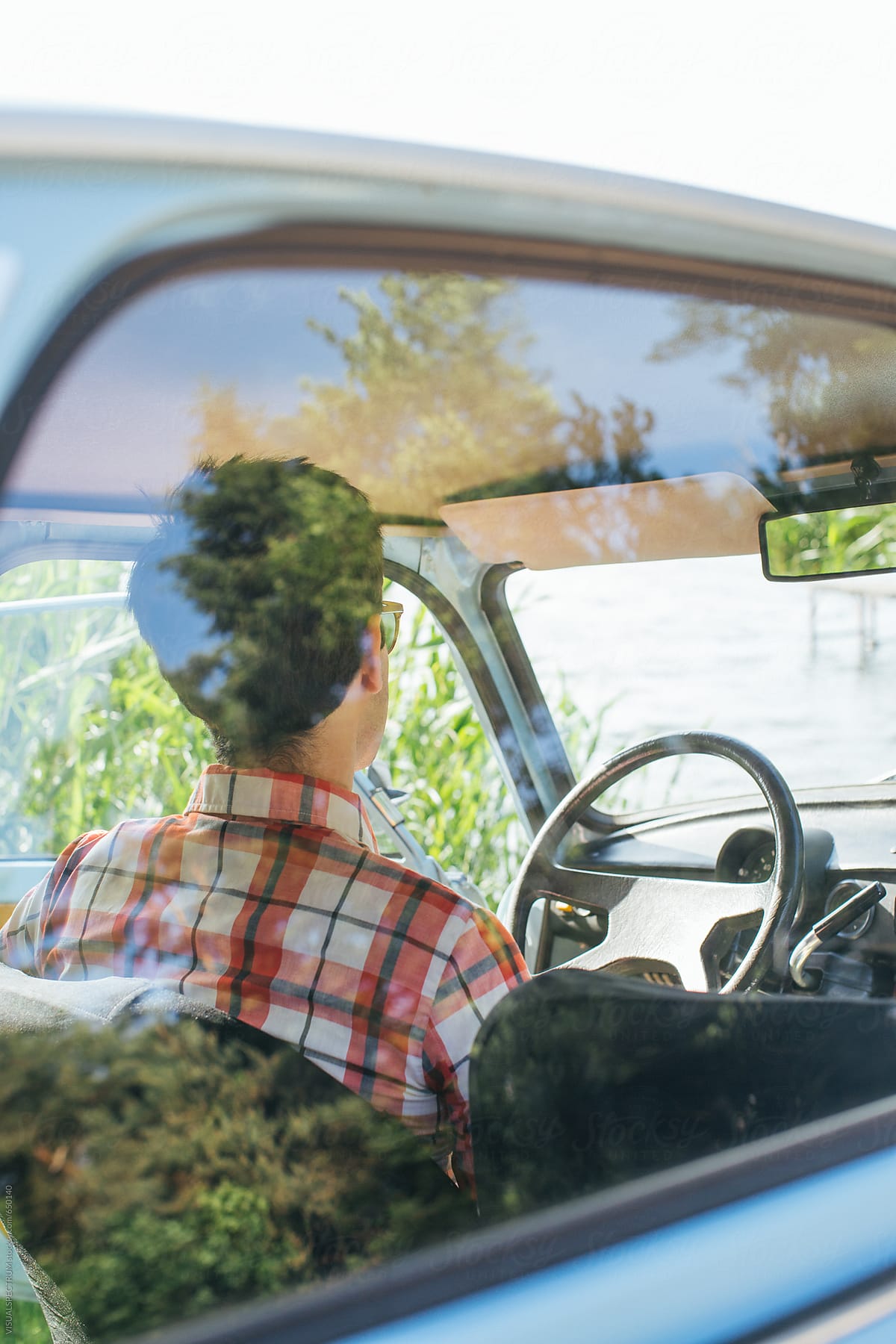 Portrait of Young Man Chilling in Vintage Car Through Car Window