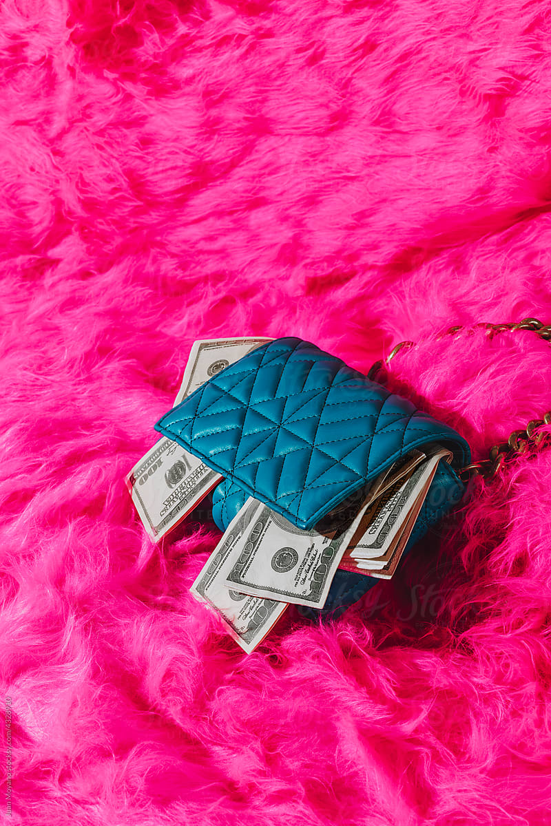 blue purse with fake dollar bills