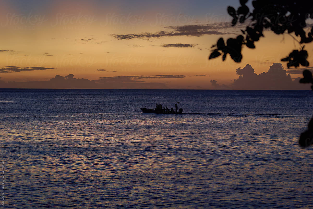 South Pacific islands dusk or dawn, speedboat silhouette at sea