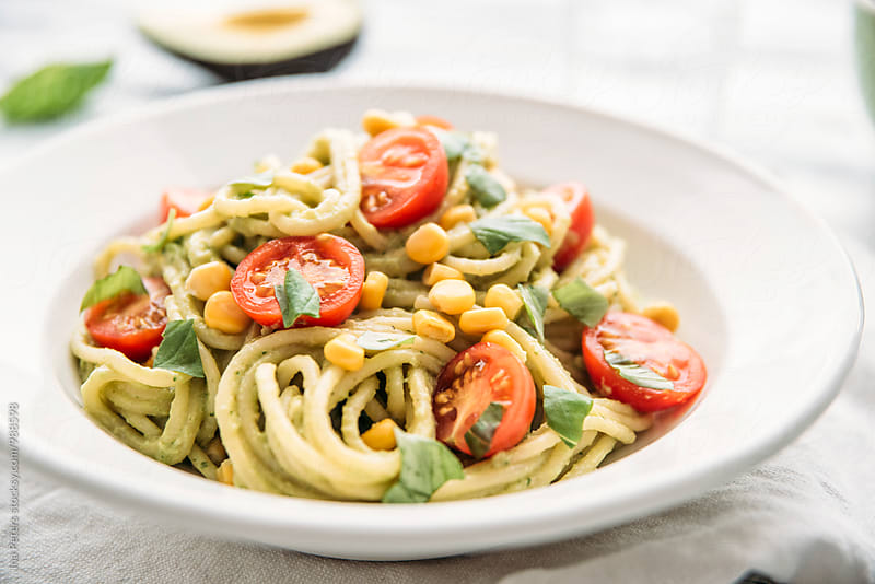 Food: Spaghetti with vegan avocado pesto with garlic, basil, cherry tomato, lemon and corn