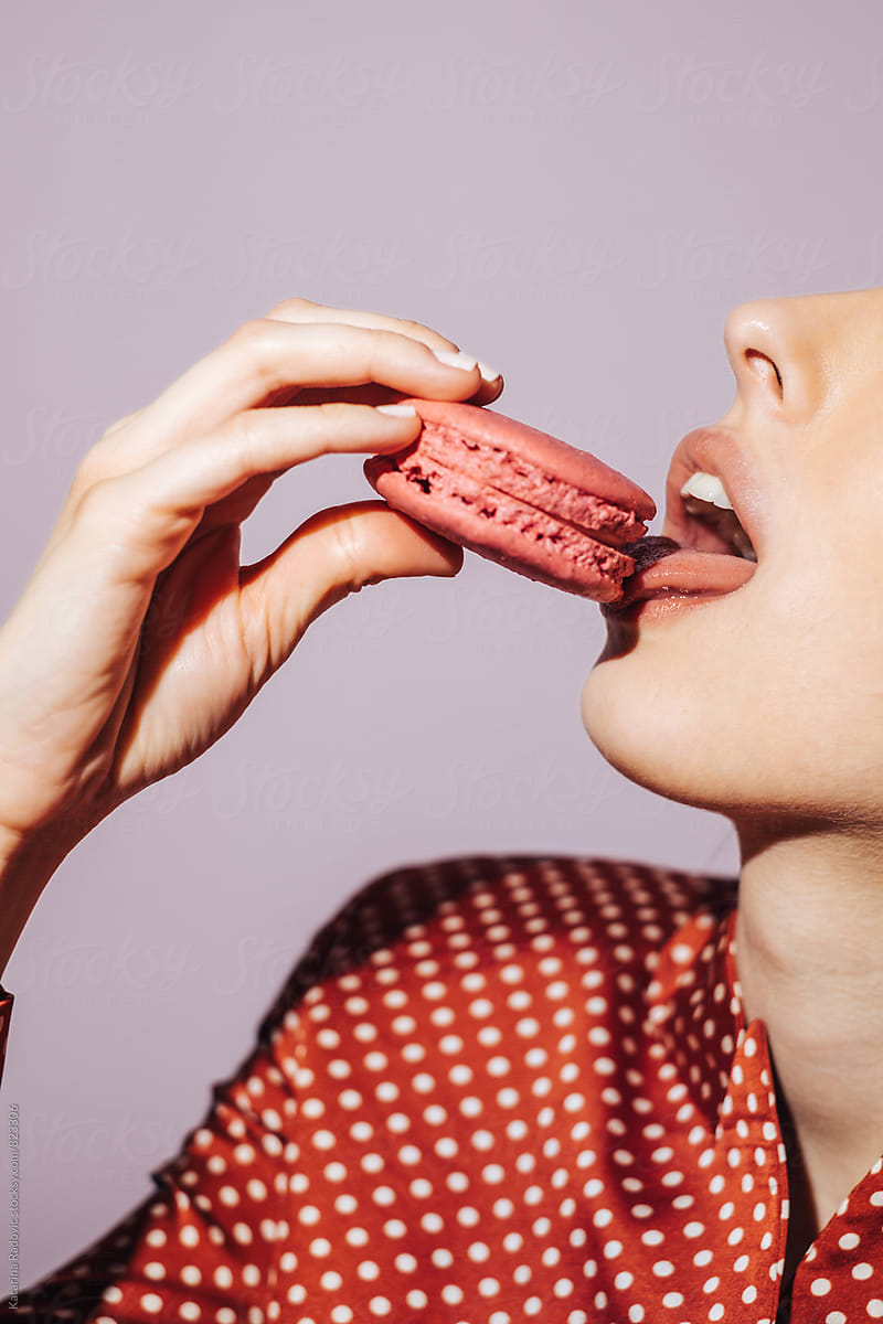 Sensual Woman Eating Pink Macaron