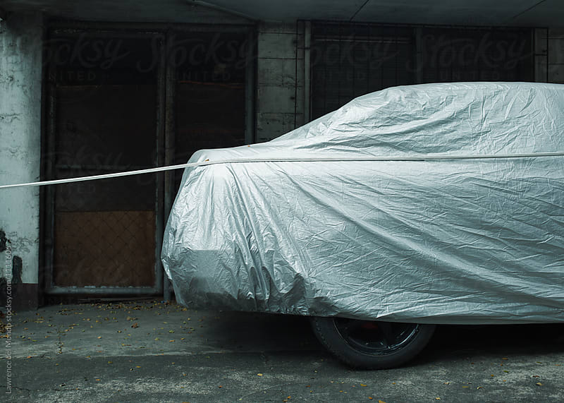 A covered parked, idle car.